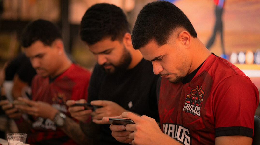 people using smartphones in group