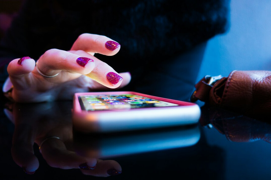 person scrolling on smartphone