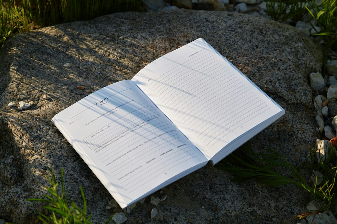 Open notebook with handwritten research notes on a desk